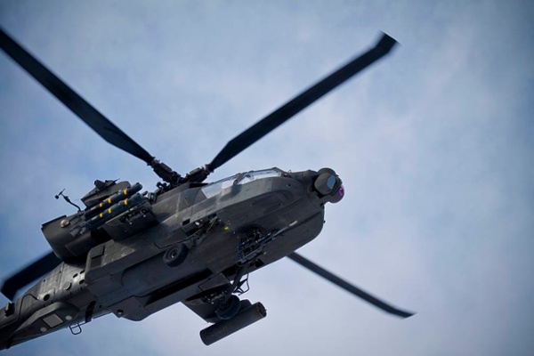 A U.S. Army AH-64 Apache attack helicopter flies overhead at Bagram Airfield, Afghanistan.